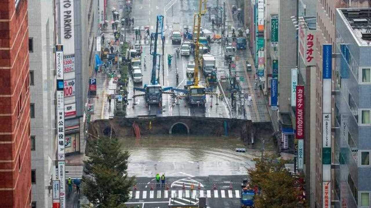 A large sinkhole cuts off an avenue in central Fukuoka, southern Japan.