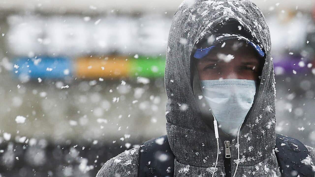 A man in a Moscow street during a snowfall