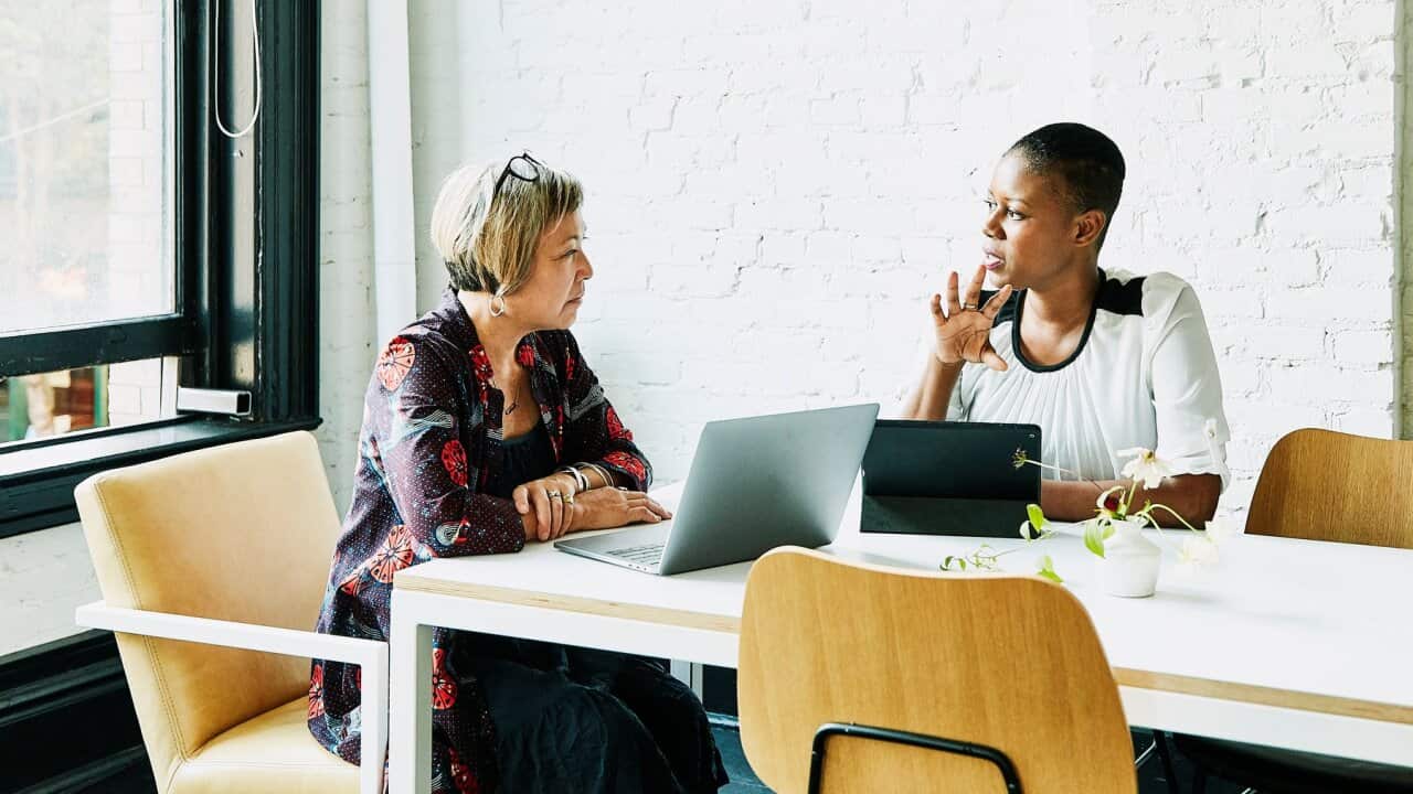 Businesswoman meeting with financial advisor in office conference room