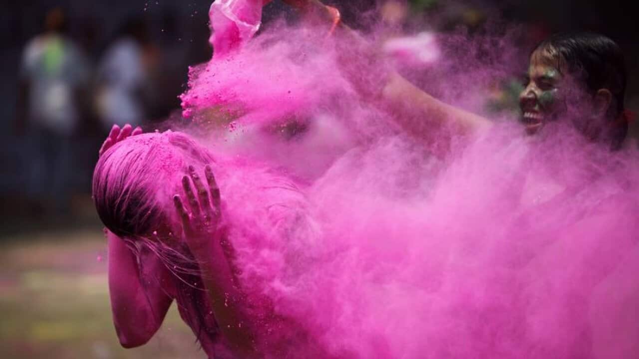 Indians throw colored powder during Holi festival celebrations in Hyderabad, India, Wednesday, March 27, 2013. Holi, the festival of colors celebrates the arrival of spring among other things.(AP Photo/Mahesh Kumar A.)