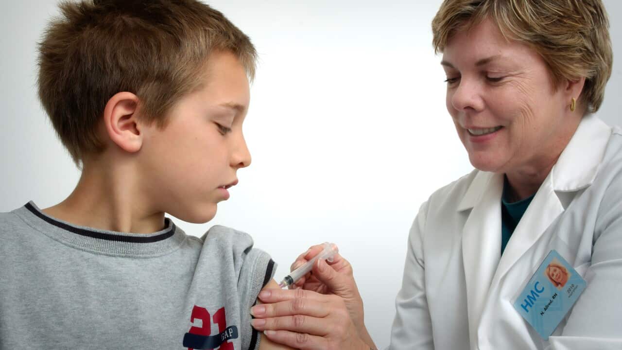 A registered nurse is given a flu shot to a boy - CDC - Unsplash.jpg