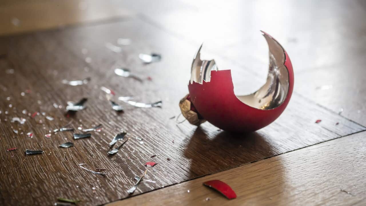 Shards of a shattered Christmas bauble on the floor