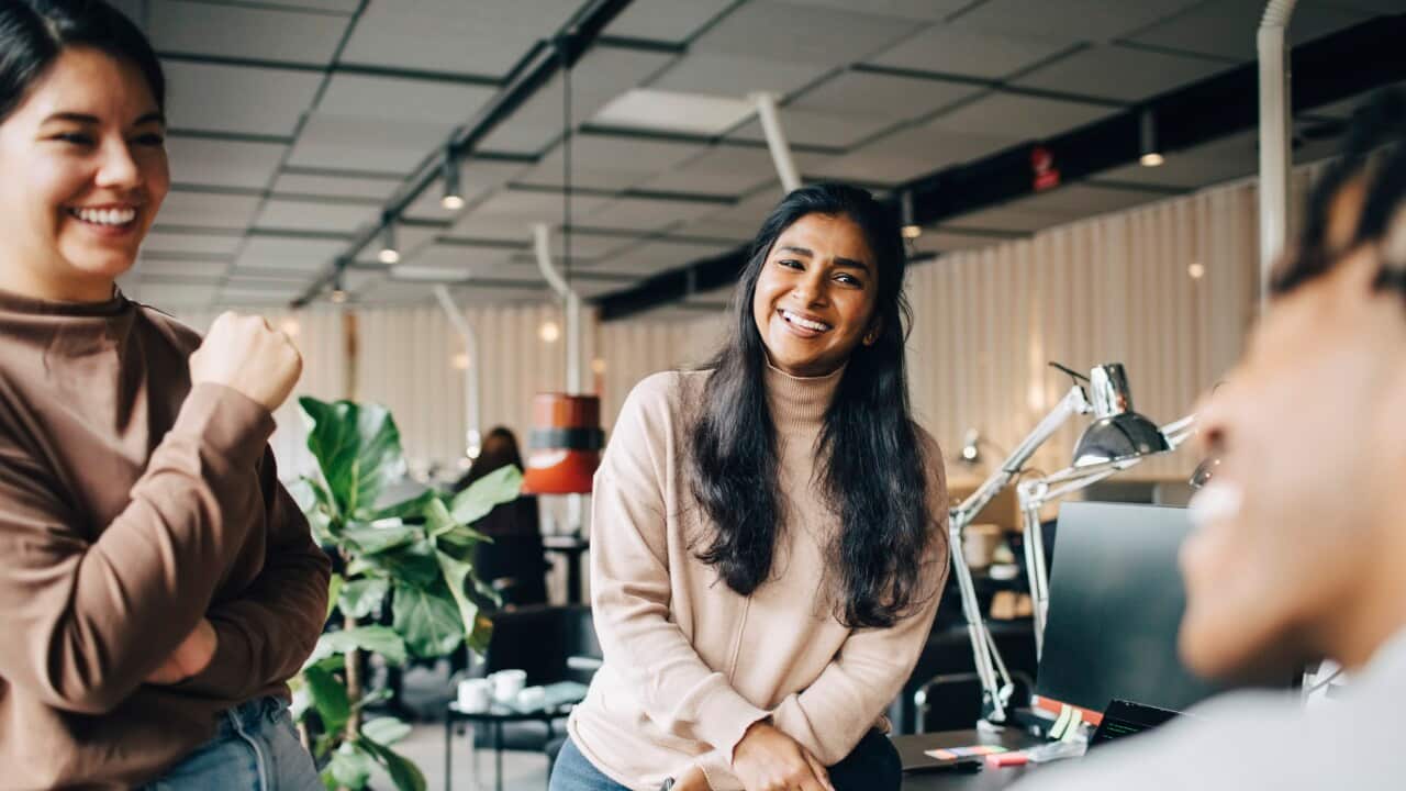 Happy female business professionals enjoying during team meeting at office