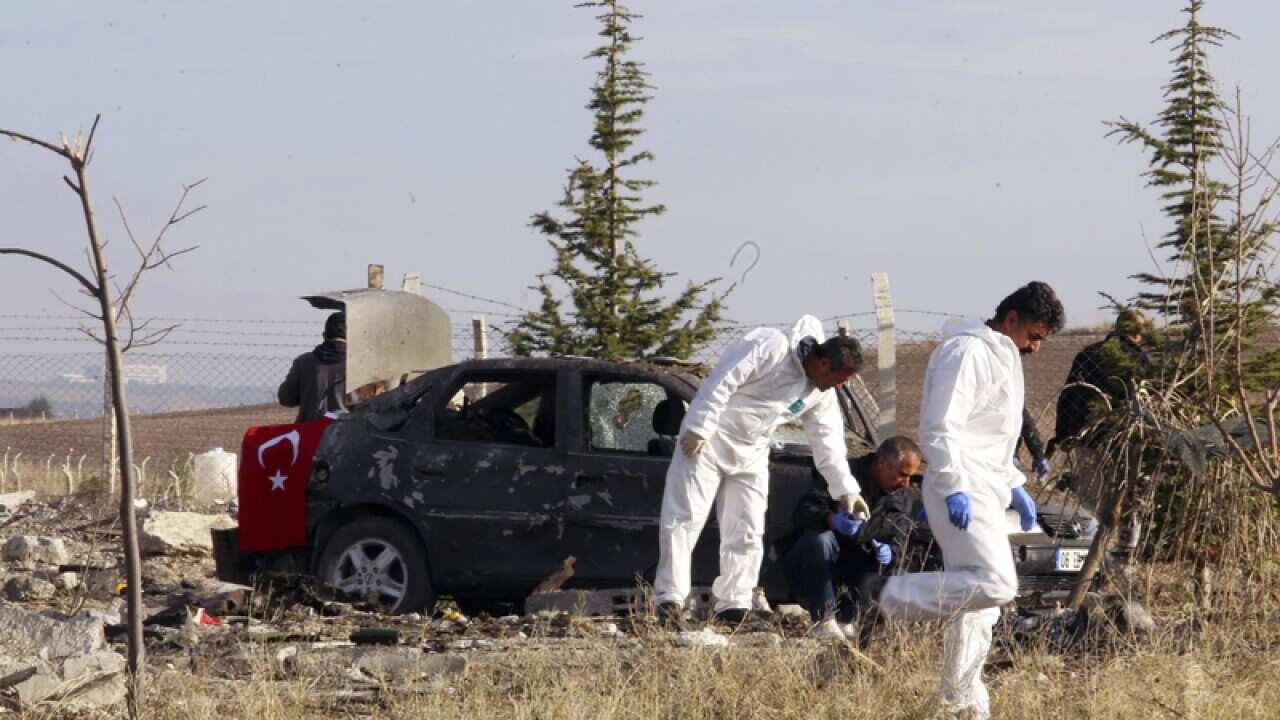 Forensic officers at the scene after a suicide bombing near Ankara