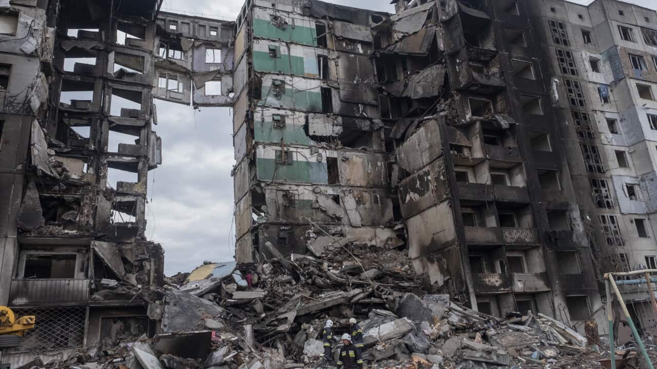A destroyed apartment block is seen.
