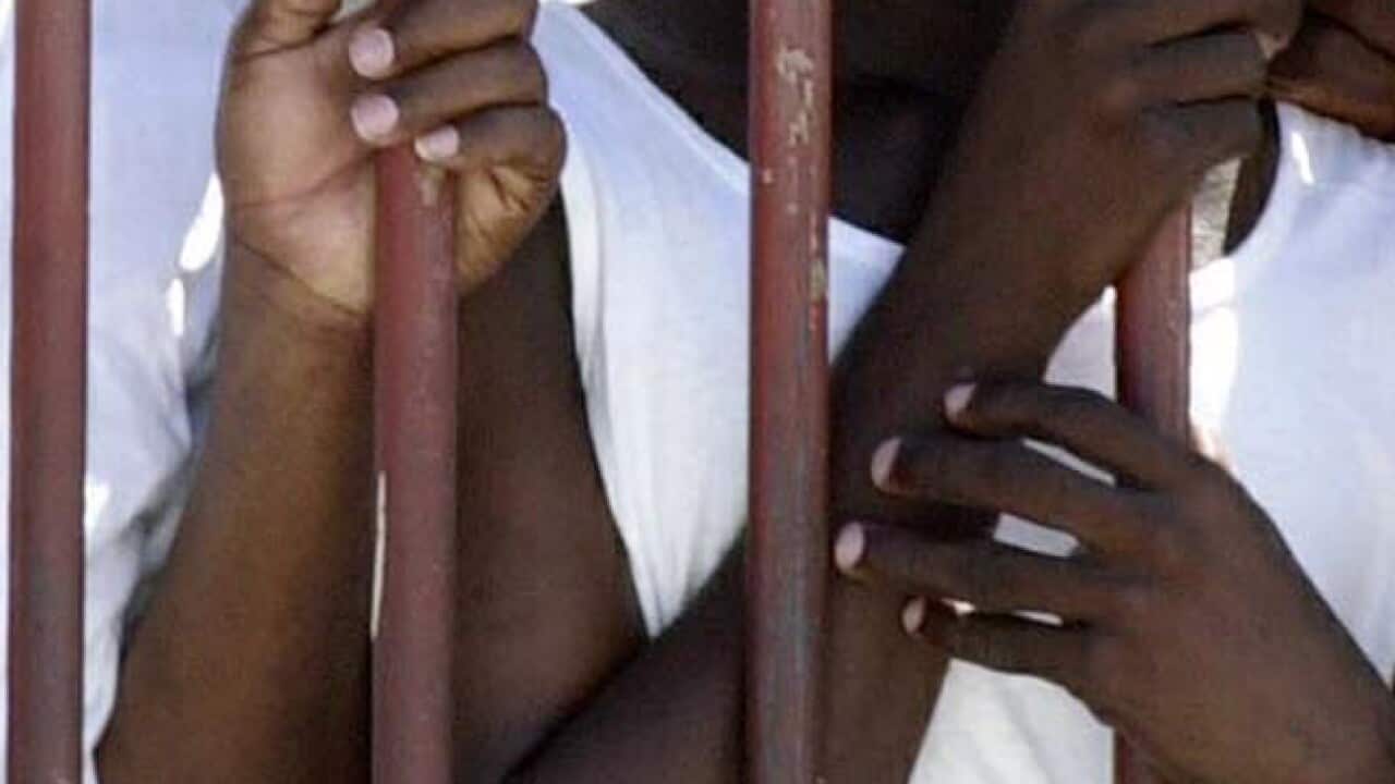 prison_bars_hands_110411_B_AAP_1300744268