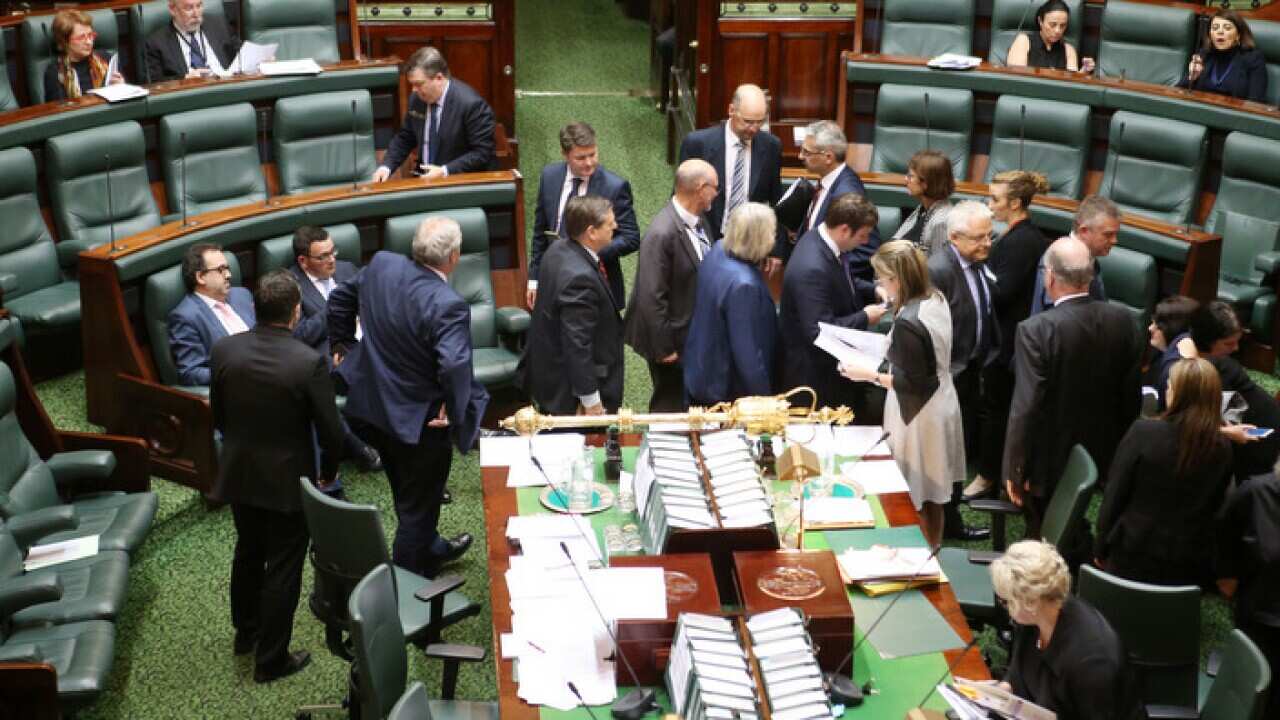 Members move around the chamber as they vote on an amendment to the Voluntary Assisted Dying Bill 2017 as it is debated in the lower house at the Victorian Parliament in Melbourne, Thursday, October 19, 2017. (AAP Image/David Crosling) NO ARCHIVING