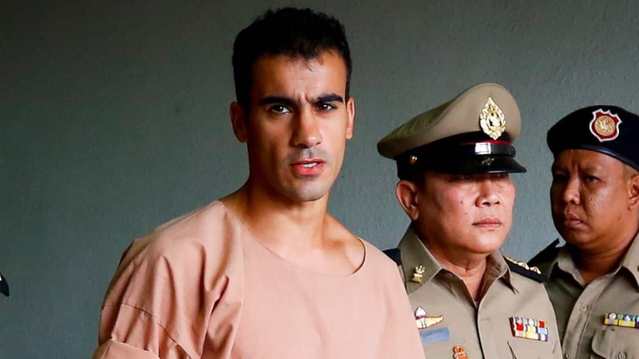 Hakeem Al-Araibi walks while escorted by Thai prison officers