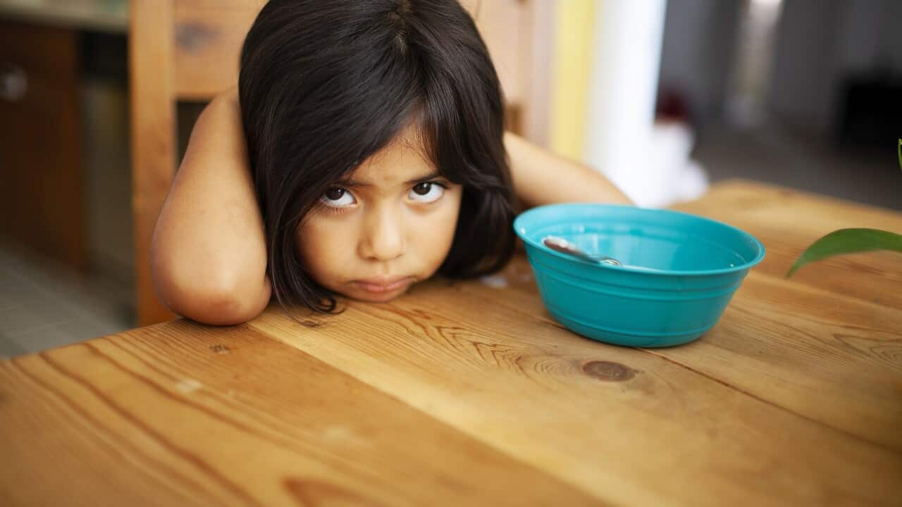 Girl Upset at Kitchen Table