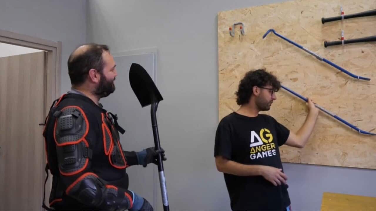 A participant chooses his weapon to enter the Rage Room (AP).jpg