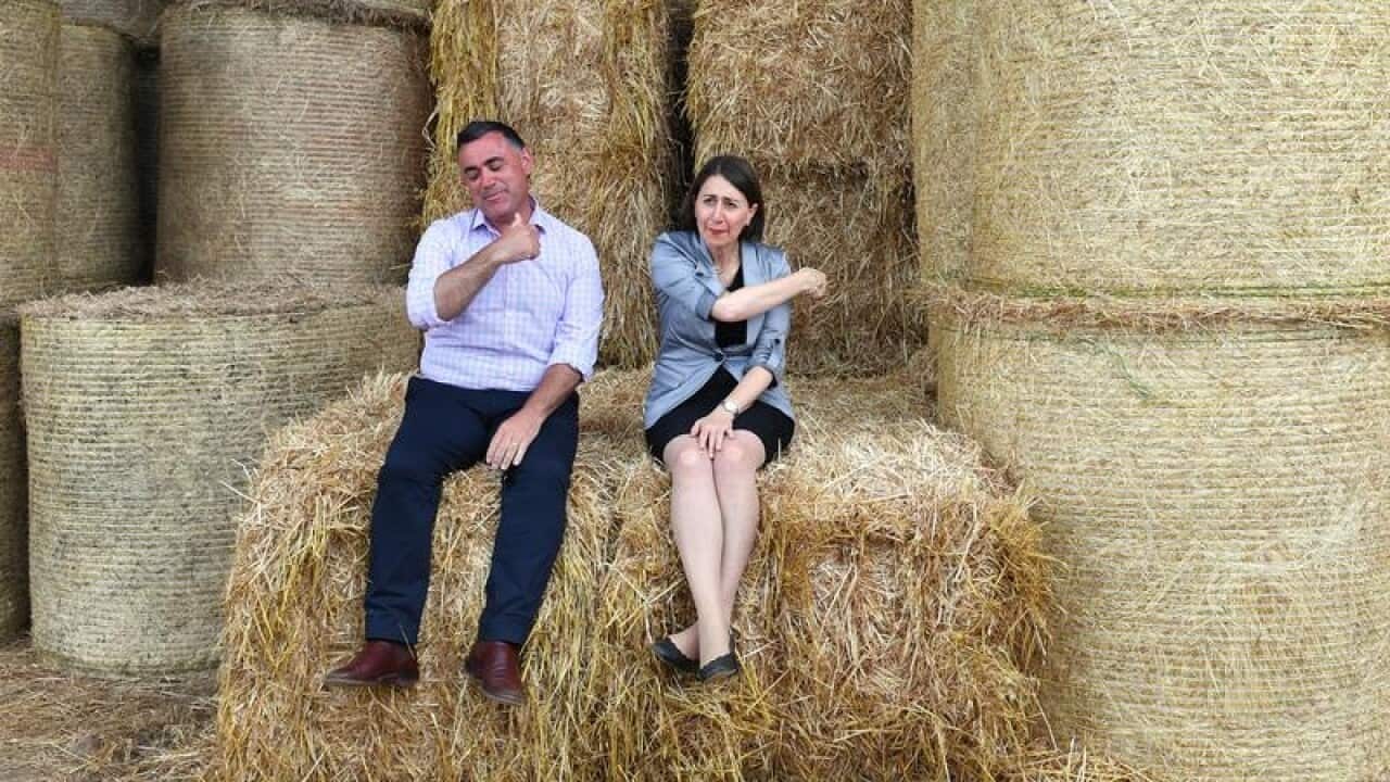 Gladys Berejiklian and Nationals leader John Barilaro at a hay farm.