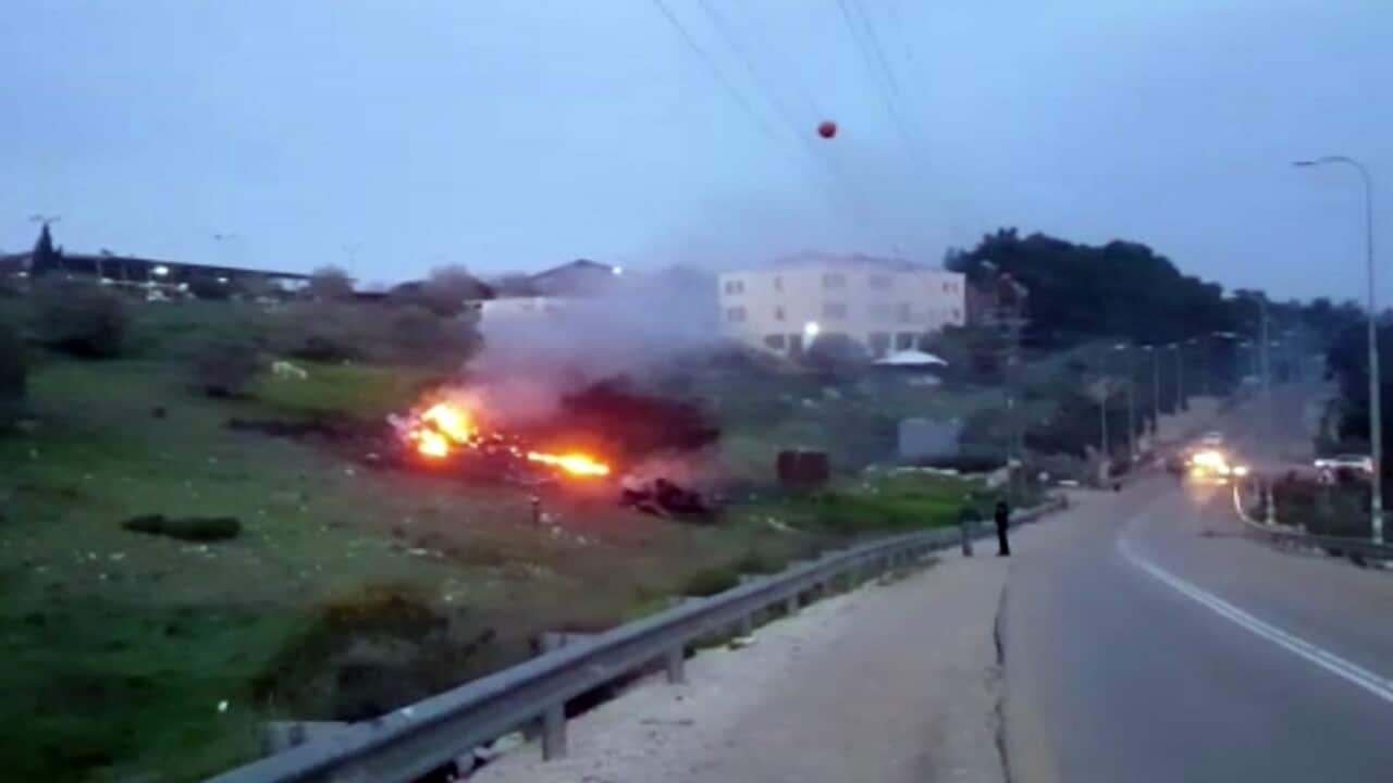 The wreckage of a jet is seen on fire near Harduf, northern Israel on Saturday.