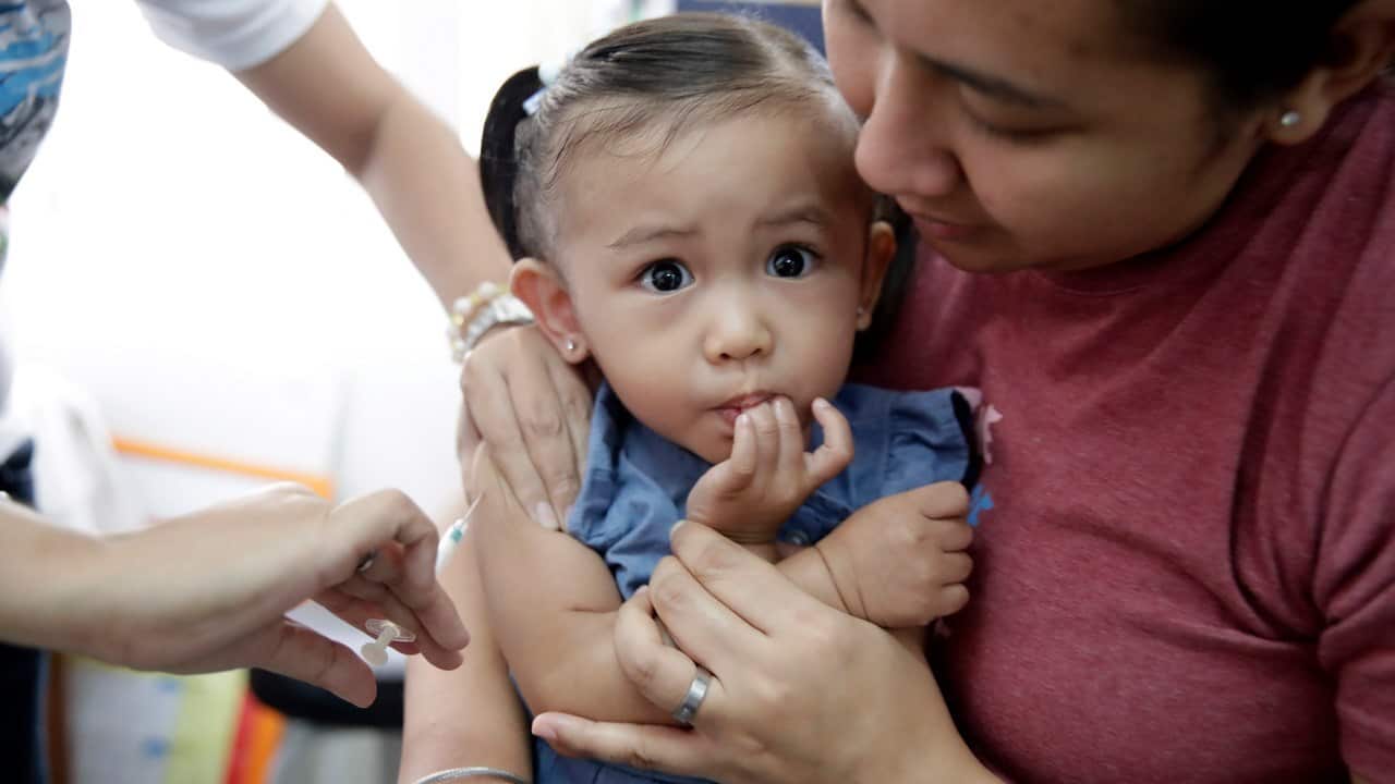 A Filipino girl receives a measles vaccine during a nationwide response immunization program inside a village health clinic in Las Pinas city on 13/2/19.
