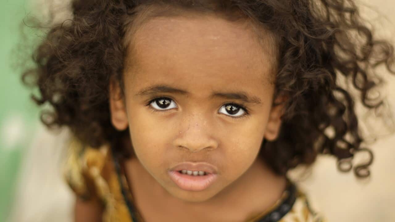 An Ethiopian girl waits with her family to be evacuated at a departure center in the western Yemeni town of Haradh, on the border with Saudi Arabia and Yemen, Wednesday, March 21, 2012.