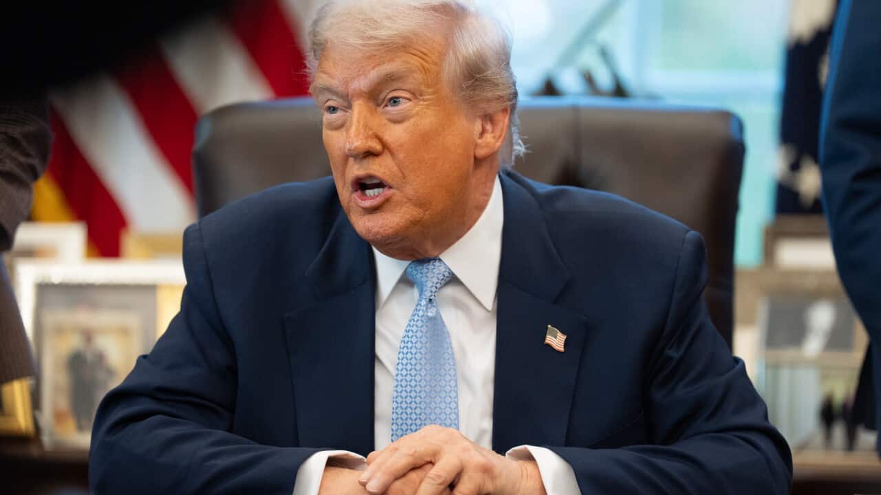 US president Donald Trump seated at his desk in the White House.