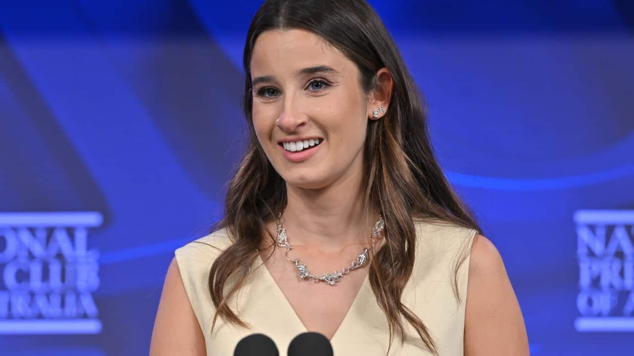 A woman speaks at a press conference.
