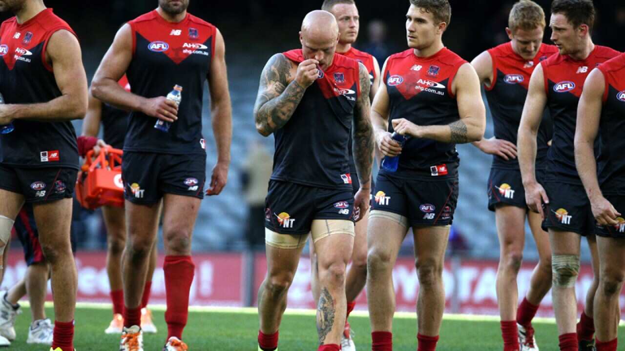 Dejected Melbourne Demons players after losing to the Brisbane Lions