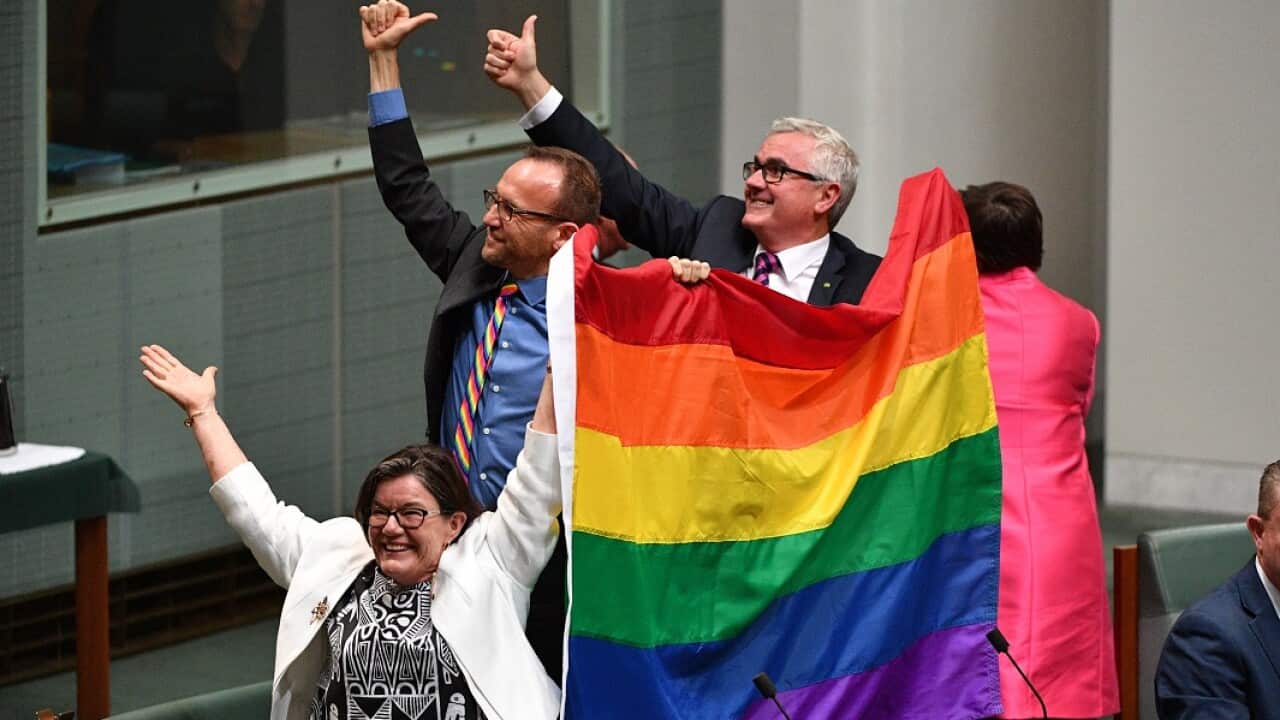 Crossbenchers Cathy McGowan, Adam Brandt and Andrew Wilkie celebrate the passing of the Marriage Amendment Bill in the House of Representatives at Parliament House in Canberra, Thursday, December 7, 2017. (AAP Image/Mick Tsikas) NO ARCHIVING