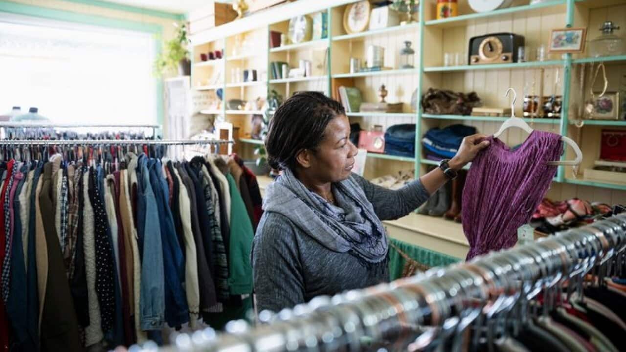 Woman shopping in vintage clothing shop
