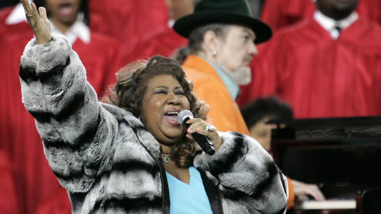Feb. 5, 2006 file photo, Aretha Franklin and Dr. John, background on piano, perform the national anthem before the Super Bowl XL football game in Detroit.