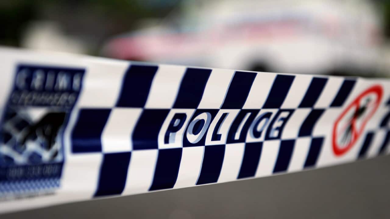 Police tape restricts access to a street