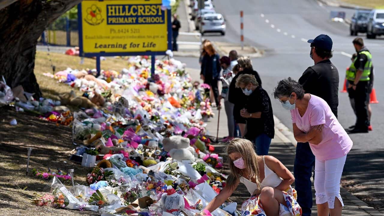 Members of the public pay their respects outside Hillcrest Primary School in Devonport, Tasmania on 22 December 2021.