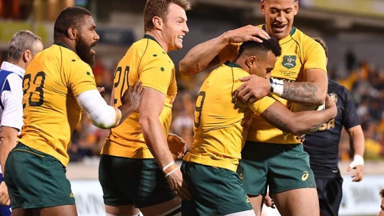 Wallabies players Israel Folau and Will Genia share an embrace