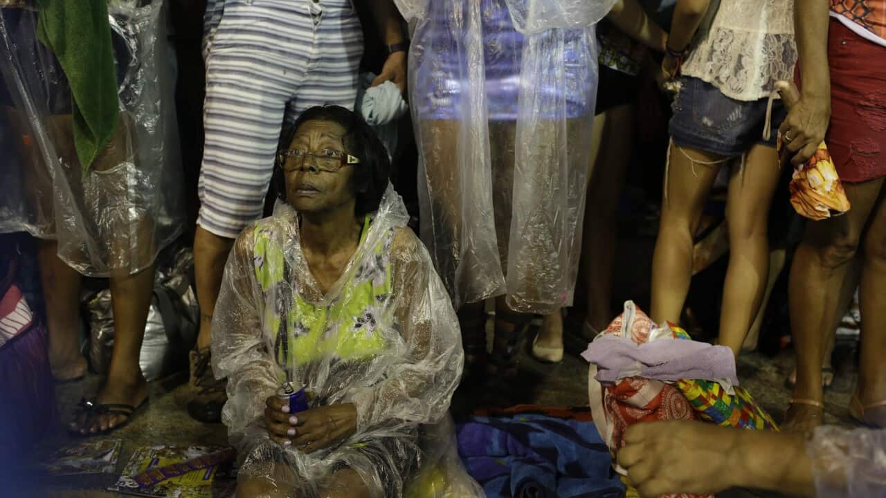 A woman watches the rescue work by firefighters
