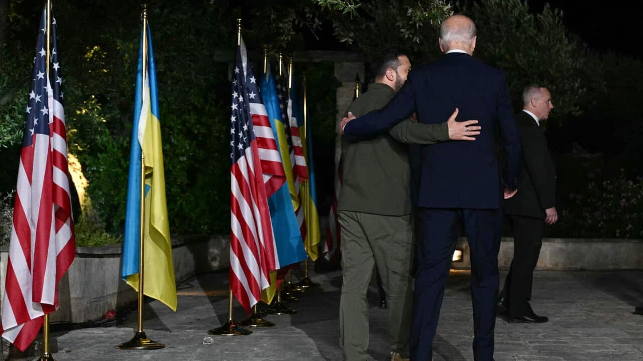 Ukrainian President Volodymyr Zelensky (L) and US President Joe Biden leave after signing a security agreement during a press conference on the sidelines of the G7 Summit.