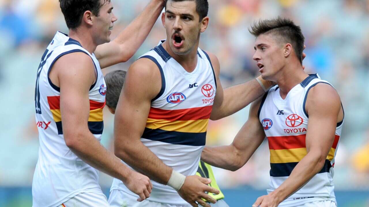 Taylor Walker of the Crows (centre) celebrates a goal