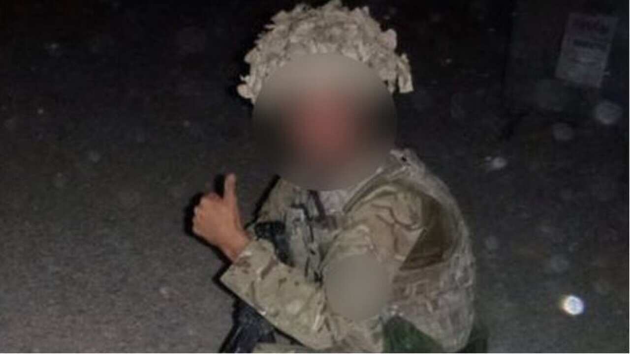 UK soldiers pose with dead Taliban fighter | SBS News