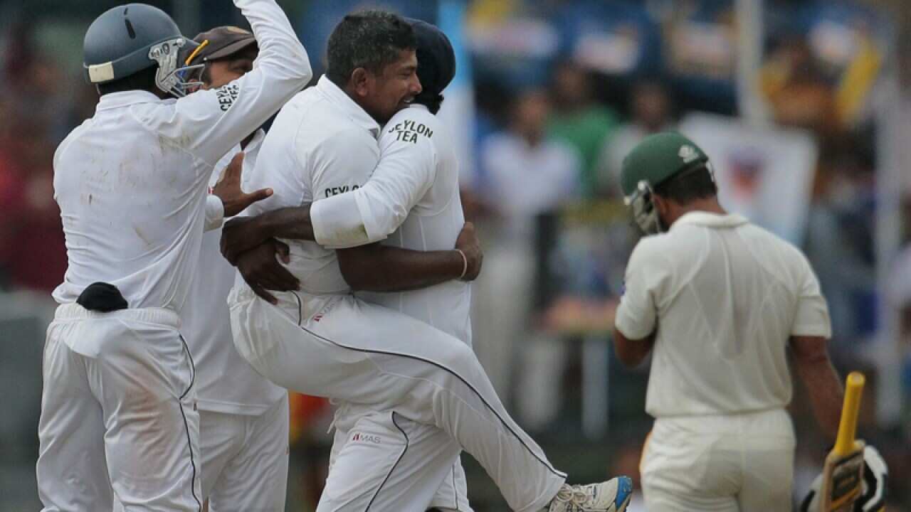 Sri Lanka celebrate getting a wicket.