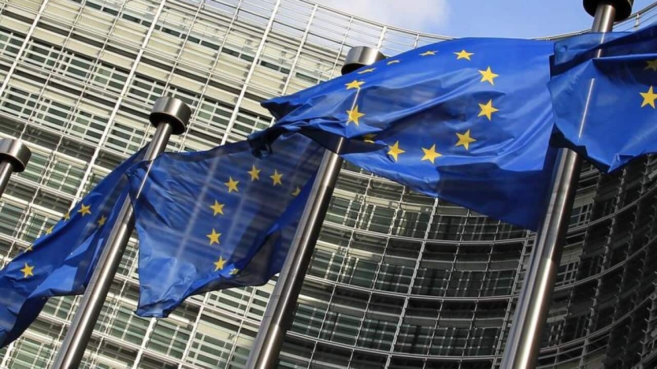EU flags wave outside the EU Commission headquarters in Brussels