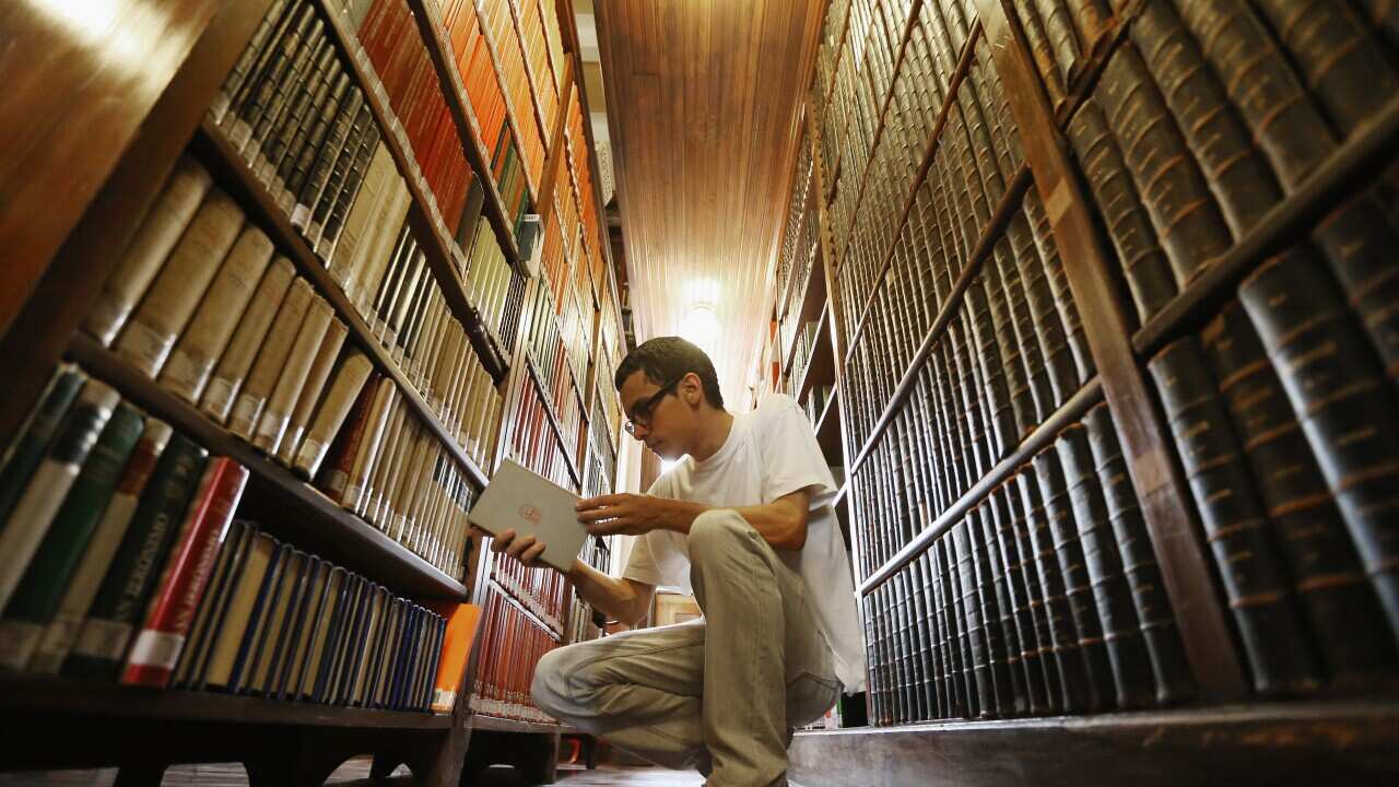 Philosphy student Sergio Araujo sorts books in a 19th-century library inside Sao Bento Monastery on March 12, 2013 in Sao Paulo, Brazil. (Mario Tama/Getty)