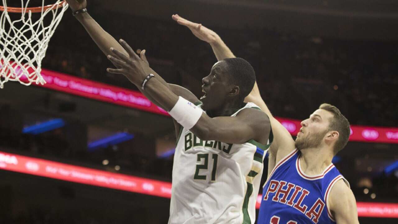 Milwaukee Bucks' Tony Snell, left, goes up to shoot