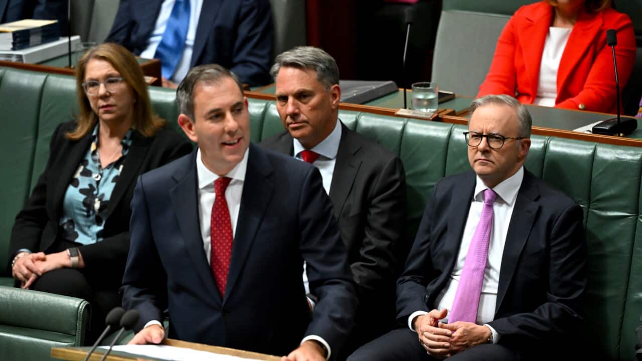 Prime Minister Anthony Albanese listens as Treasurer Jim Chalmers delivers the 2024/25 Budget