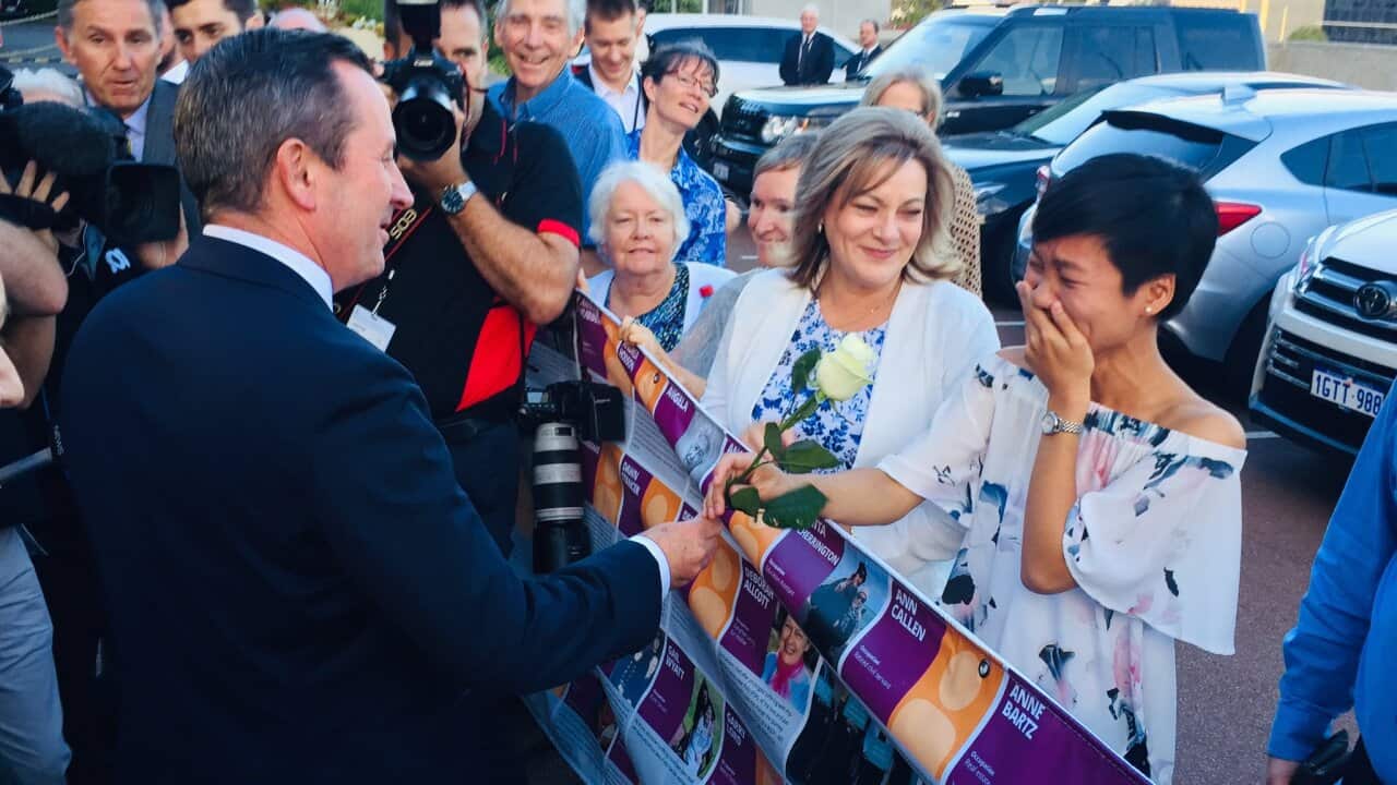 WA Premier Mark McGowan hands a white rose to assisted dying supporter Belinda Teh