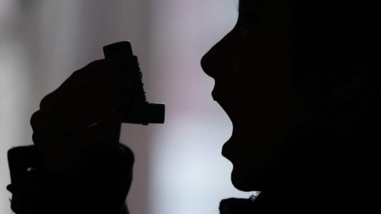 An asthma sufferer with an inhaler