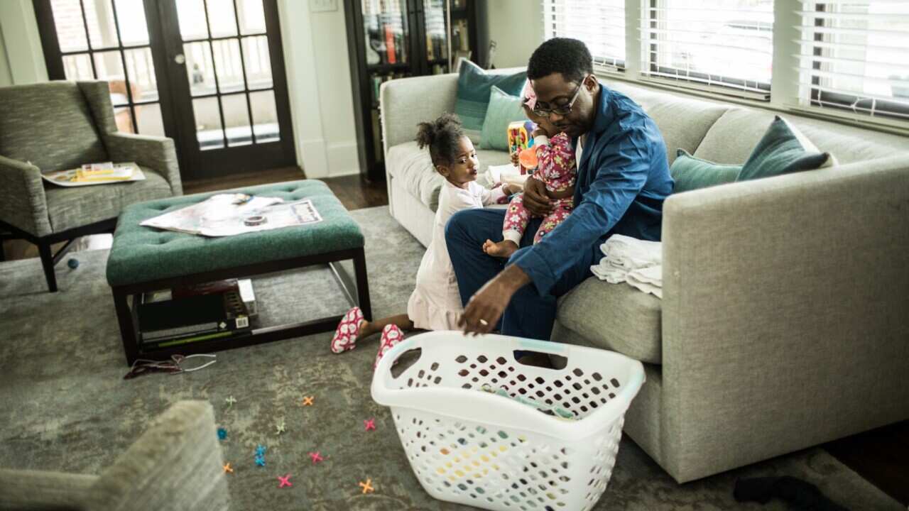 Dad with laundry - Getty Images_MoMo Productions.