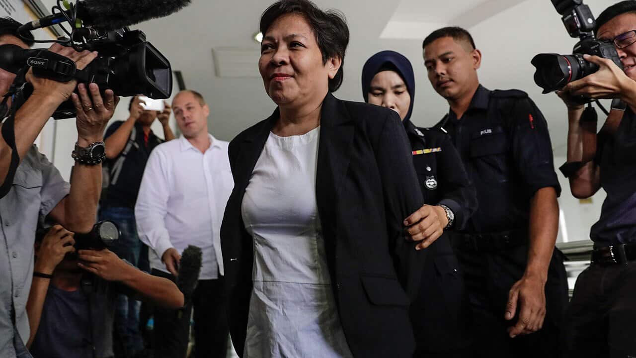 Australian Maria Elvira Pinto Exposto (C), escorted by Royal Malaysian Police (RMP) officers.