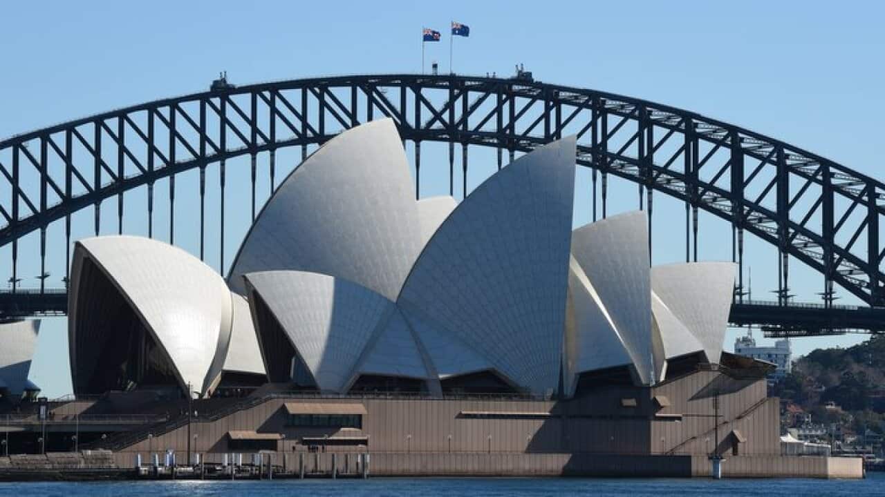 The sails of the Sydney Opera House set against the Sydney Harbour Bridge in Sydney