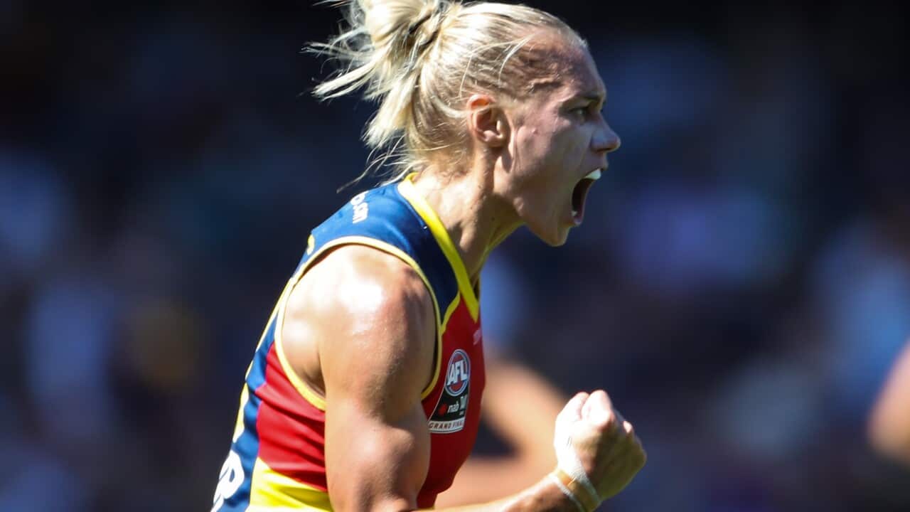 A female footballer cheering.