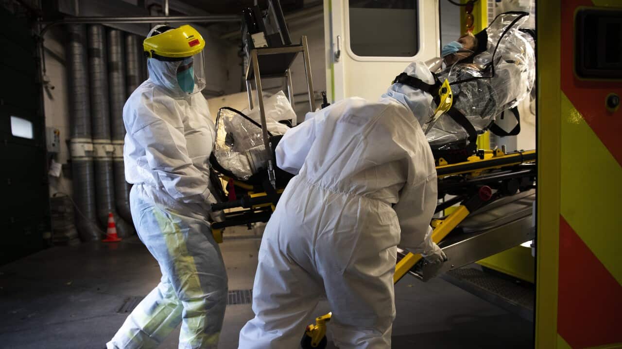 Medical staff transfer a COVID-19 patient into an ambulance at the CHR Citadelle hospital in Liege, Belgium, Wednesday, 21 October, 2020.