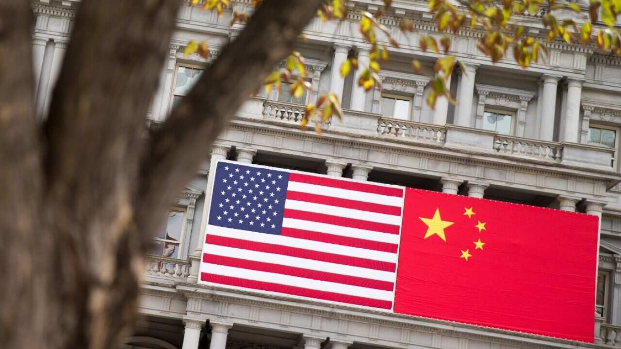 File image of China's flag is displayed next to the American flag on a US government building