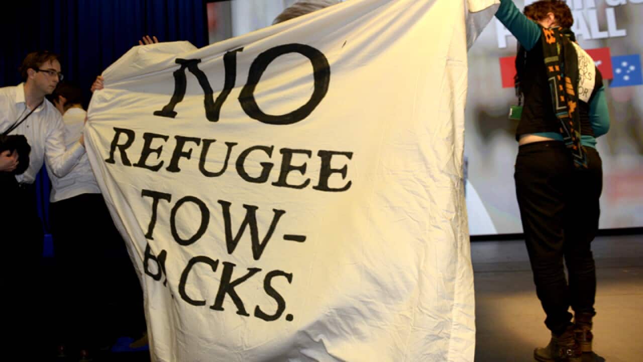 Protesters interrupt Andrew Giles speech