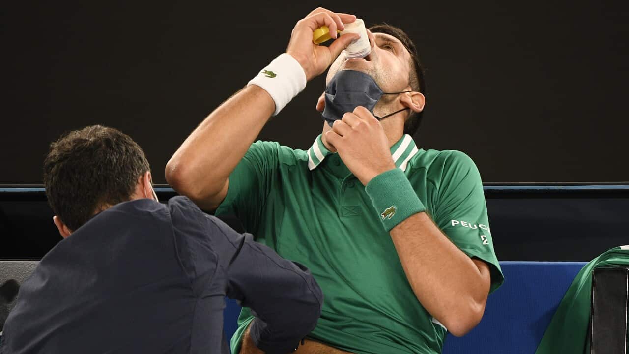Serbia's Novak Djokovic receives treatment during his third round match against United States' Talyor Fritz at the Australian Open tennis championship in Melbourne, Australia, Friday, Feb. 12, 2021.(AP Photo/Andy Brownbill)