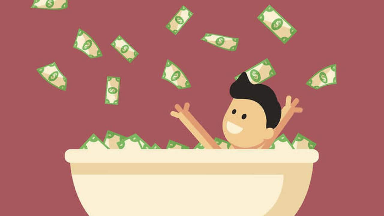 Bath full of money with happy man in it.