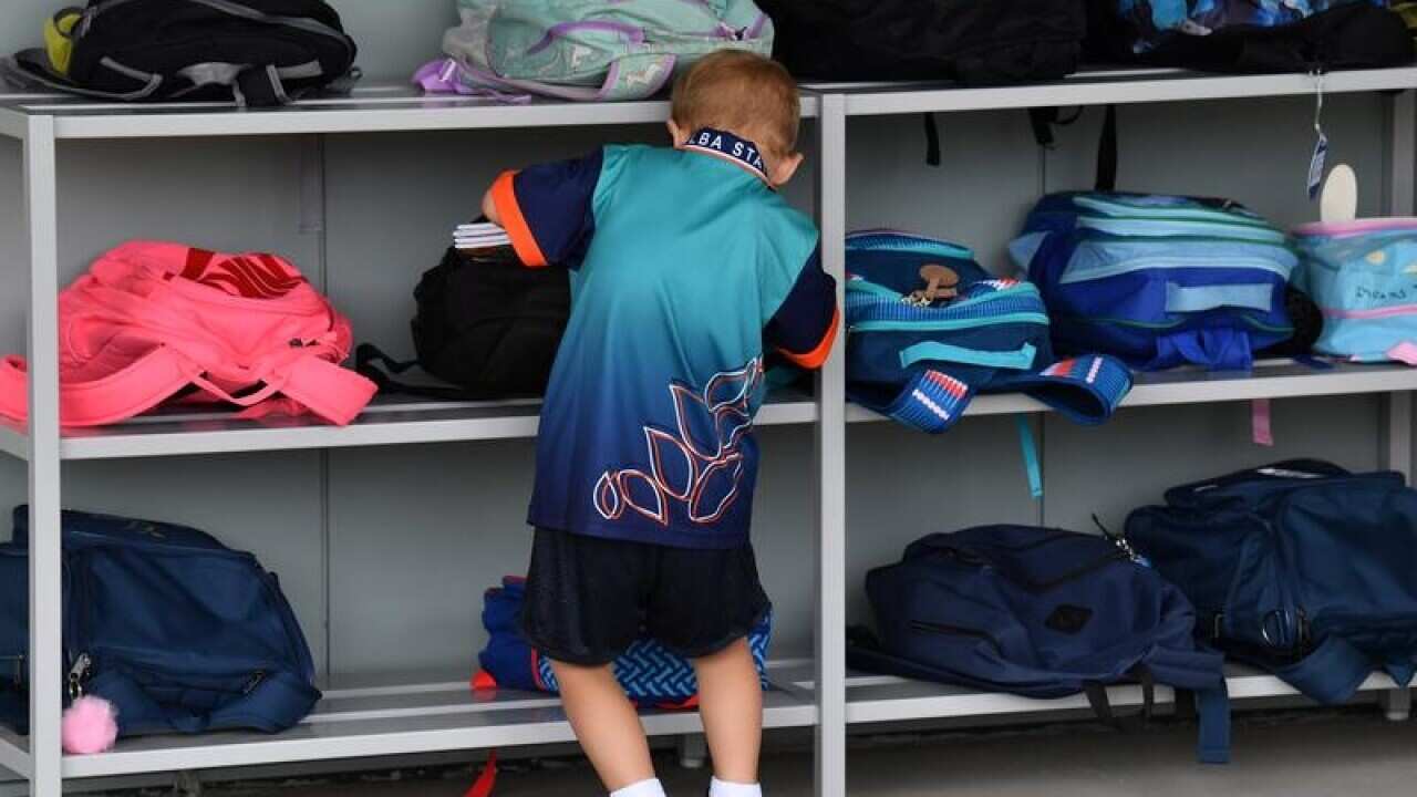 A prep student is seen at his school bag at a primary school in Logan.