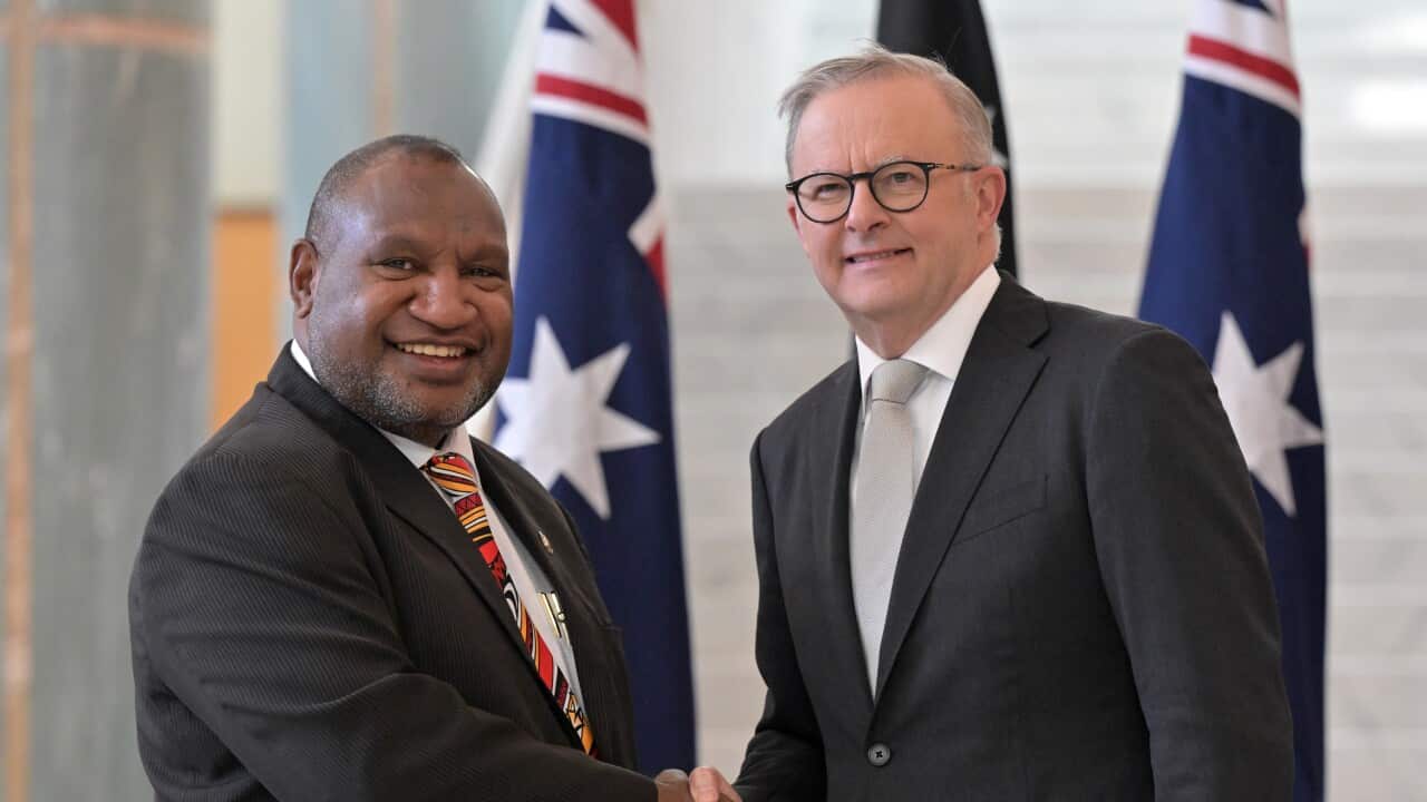 James Marape and Anthony Albanese shaking hands and smiling.