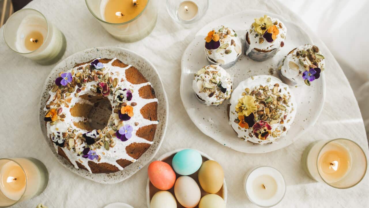 Easter table setting with freshly baked, vegan, traditional Polish Easter babka cake and multicolour easter eggs.